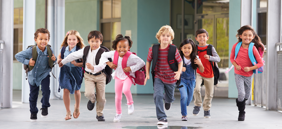 Elementary students running into school